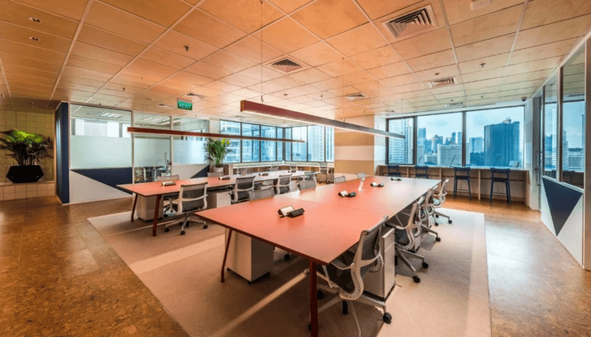 Modern conference room with large windows offering city views and a spacious table setup.