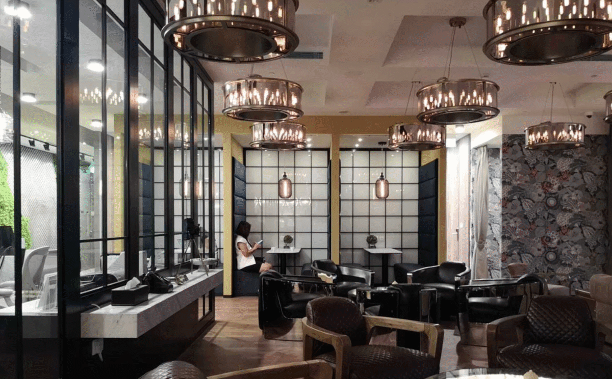 Elegant coworking lounge with pendant lighting, private booths, and a stylish modern-industrial design